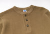 Brown textured shirt with buttons on a white background