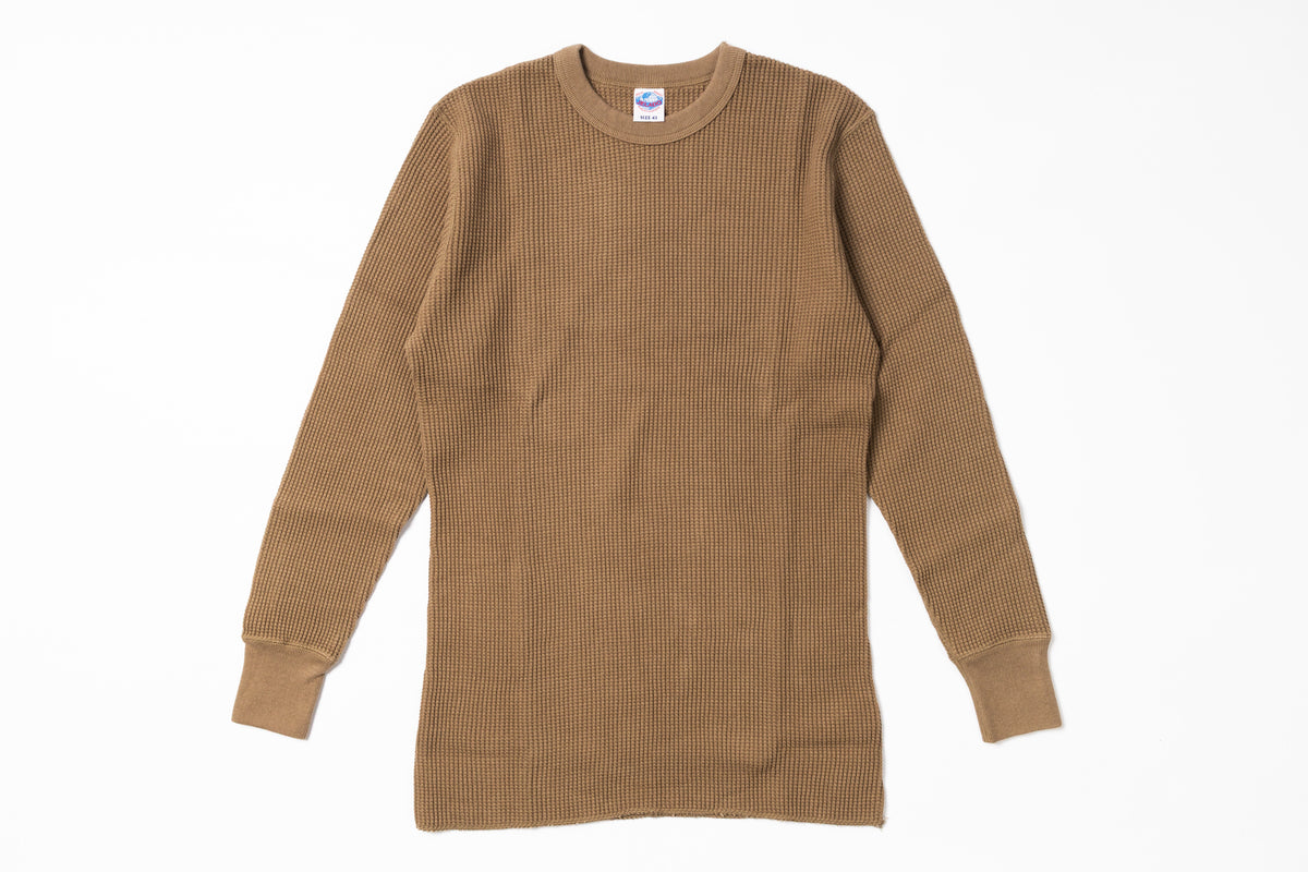 Brown ribbed sweater on a white background