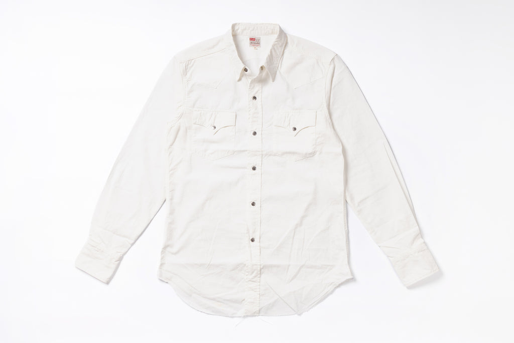 An off-white long-sleeve button-down shirt with two chest flap pockets, laid flat on a white background.
