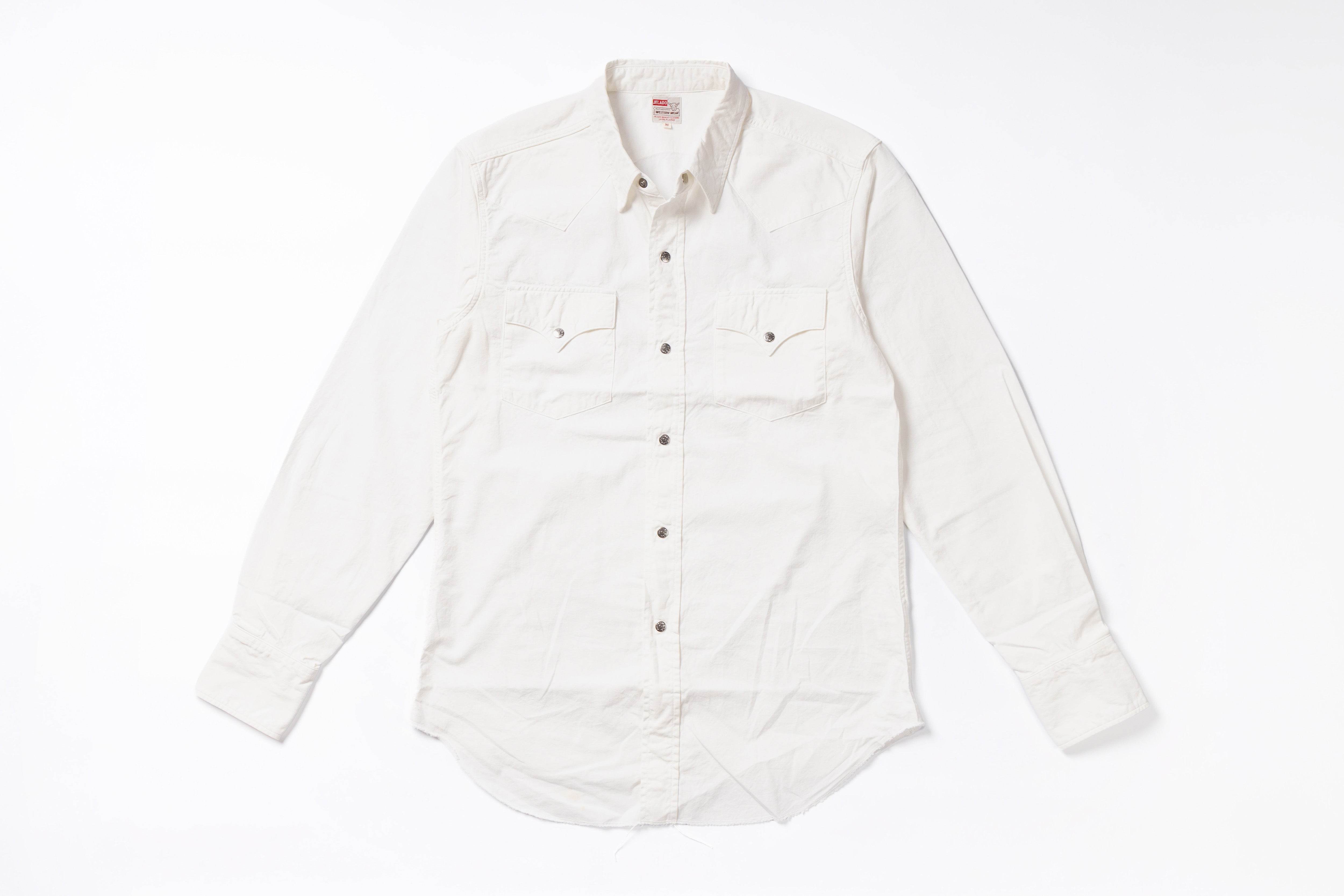 An off-white long-sleeve button-down shirt with two chest flap pockets, laid flat on a white background.