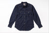 A dark indigo denim western-style shirt jacket with two buttoned chest pockets, laid flat on a white background.