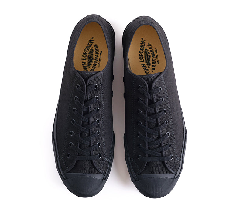 Pair of black sneakers with brand logo on a white background