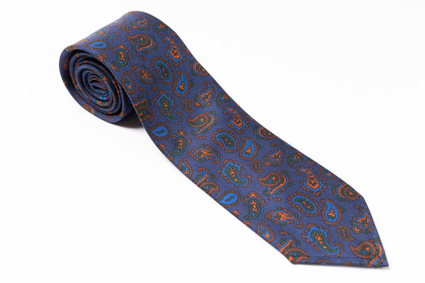 Blue paisley patterned tie on a white background