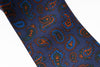 Blue paisley patterned tie on a white background
