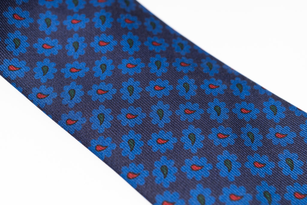 Navy blue tie with blue floral pattern on a white background