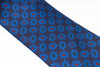 Navy blue tie with blue floral pattern on a white background
