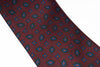Patterned tie with geometric design on a plain background