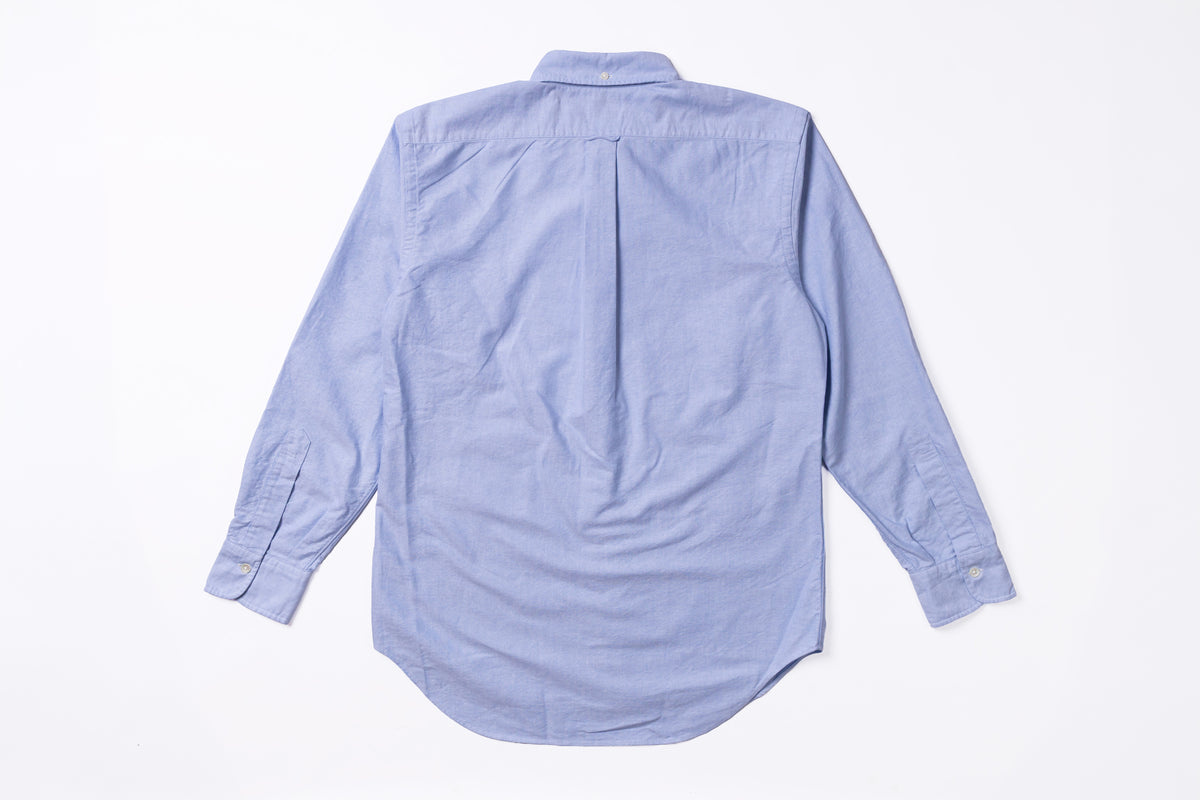 A light blue long-sleeve button-up shirt shown from the back, laid flat on a white background.