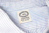 Close-up of a striped fabric with a label on a white background