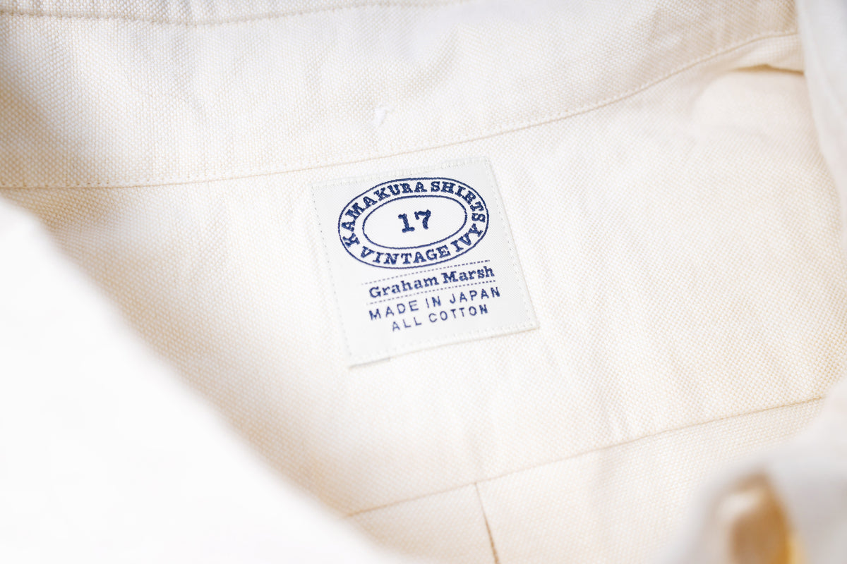 Close-up of a ecru fabric with a label on a white background