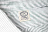 Close-up of a striped fabric with a label on a white background