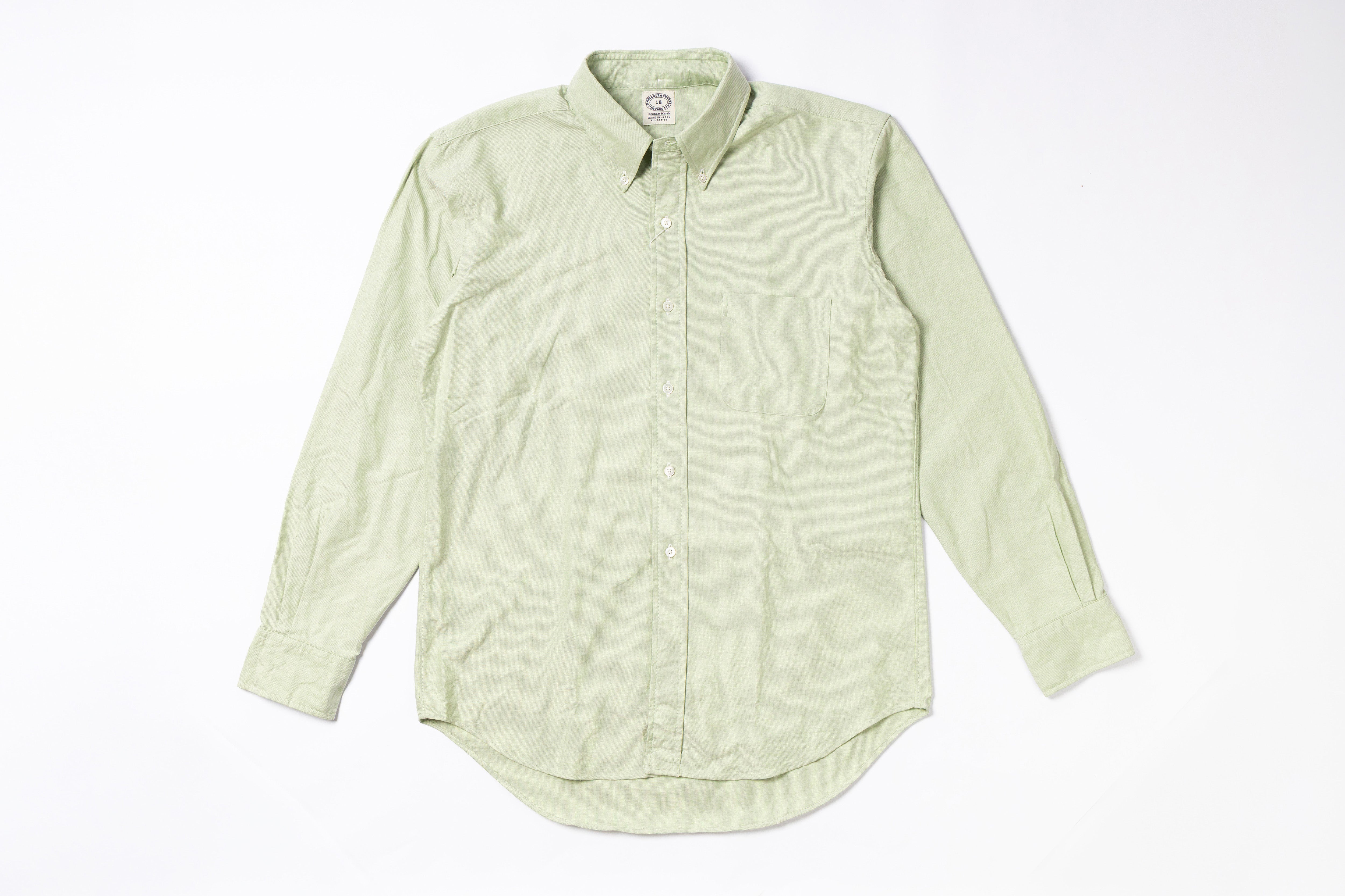 Light green button-up shirt on a white background