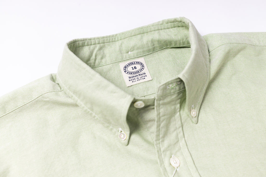 Light green shirt collar with a brand label on a white background