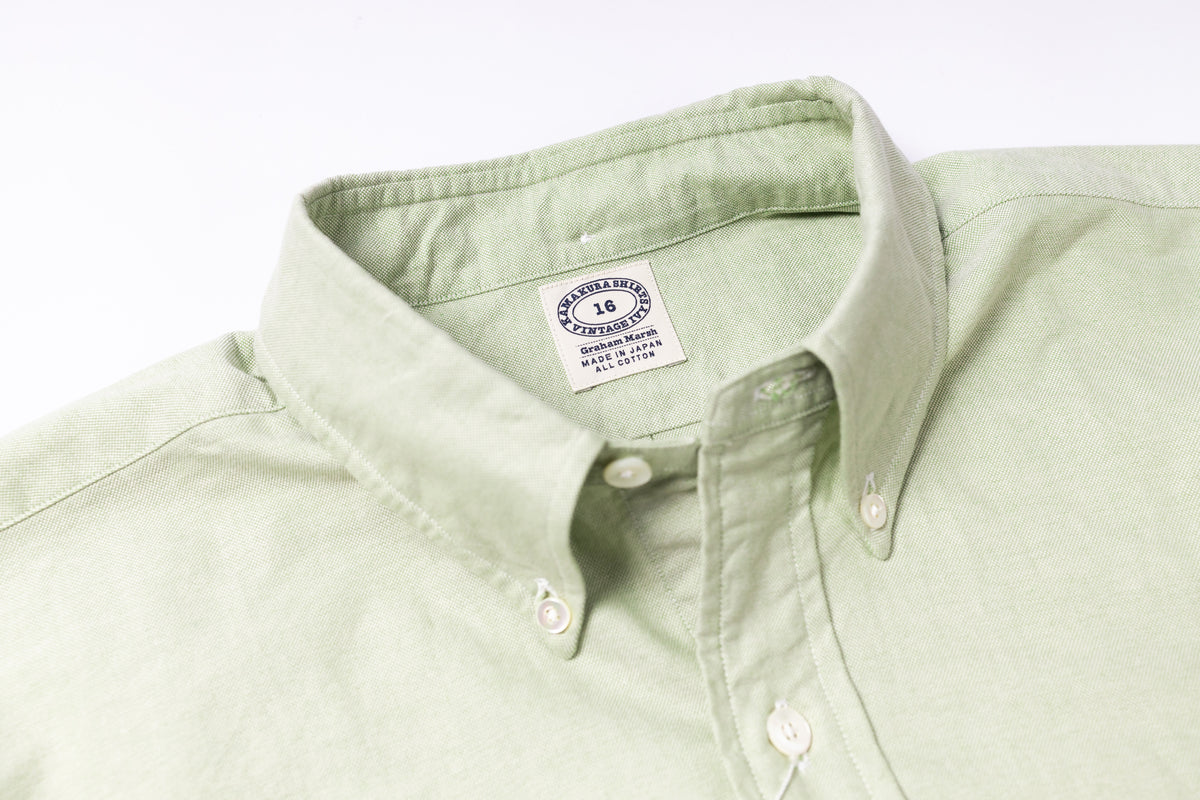 Light green shirt collar with a brand label on a white background