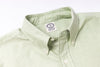 Light green shirt collar with a brand label on a white background