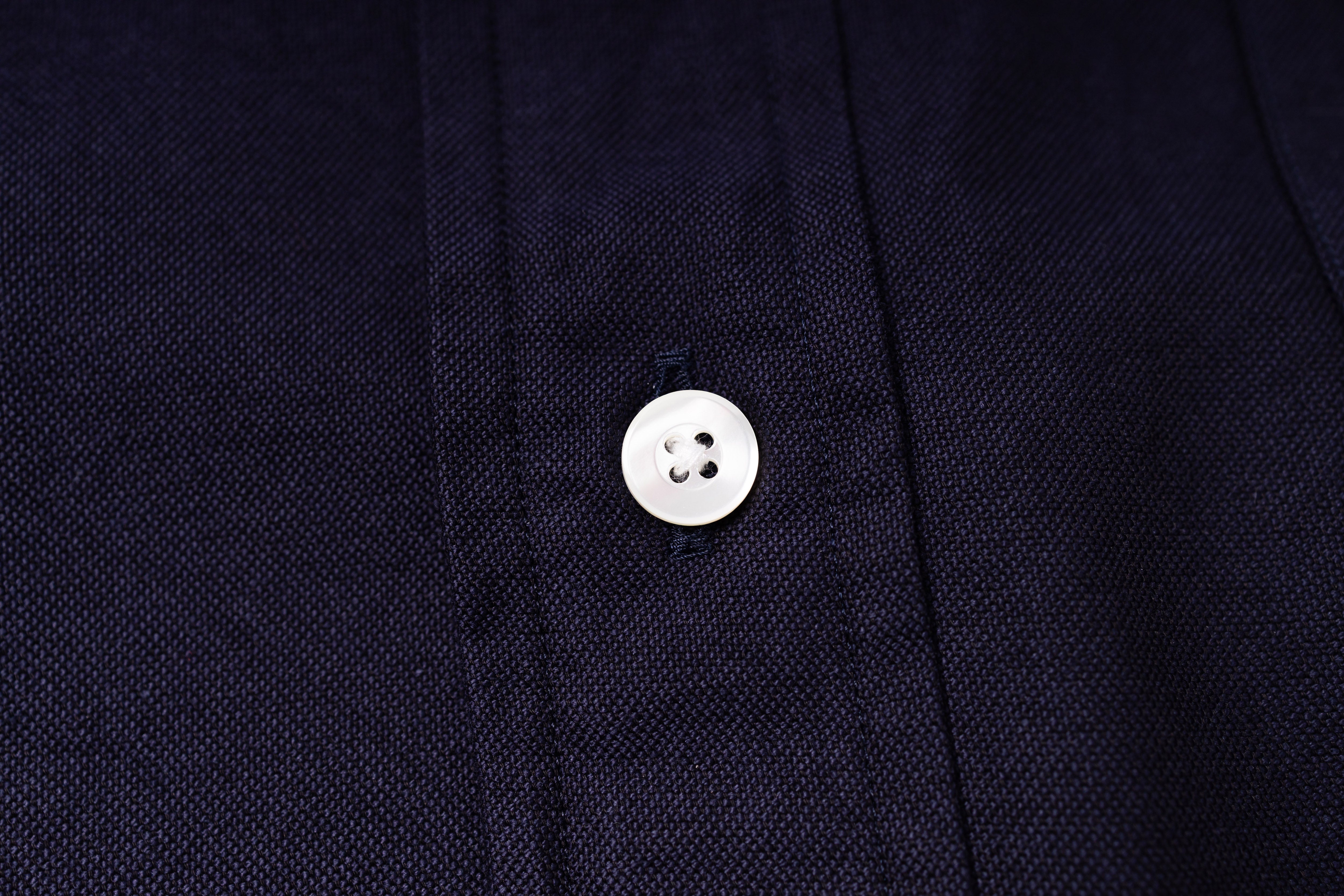 Close-up of a button on an navy fabric shirt