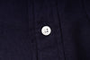 Close-up of a button on an navy fabric shirt