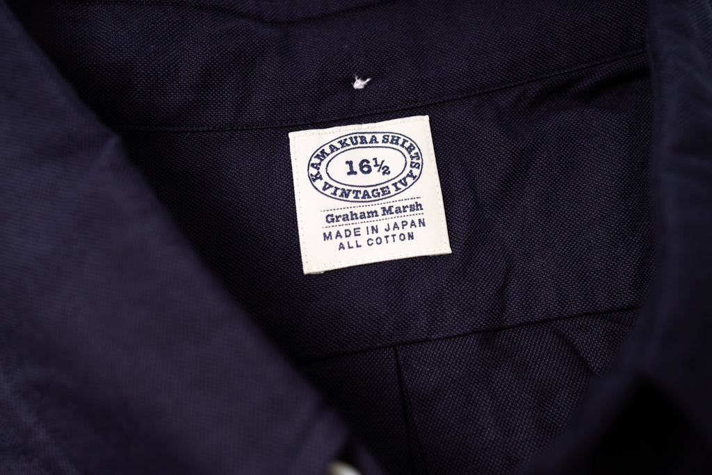 Close-up of a navy fabric with a label on a white background 