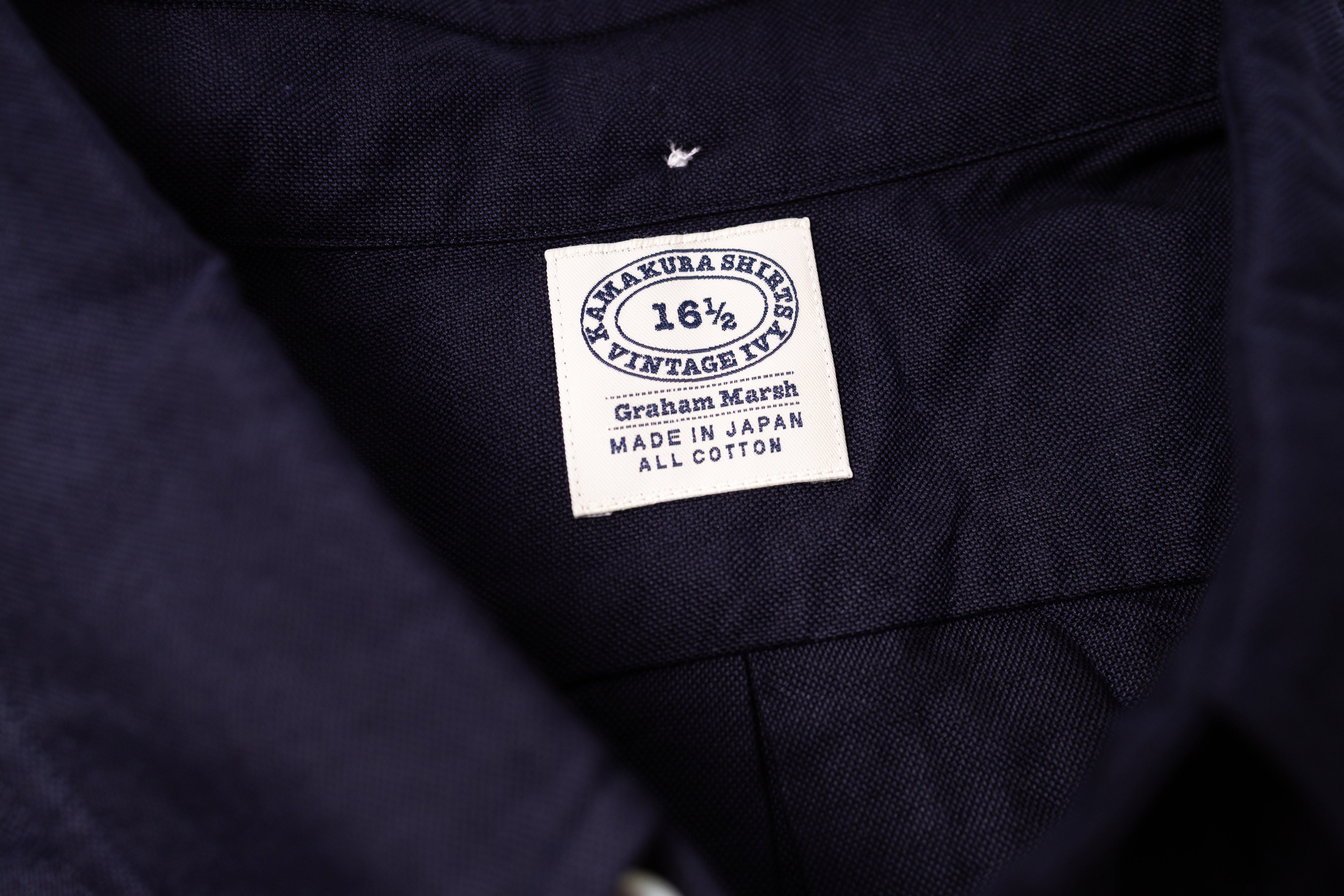 Close-up of a navy fabric with a label on a white background 