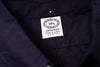 Close-up of a navy fabric with a label on a white background 