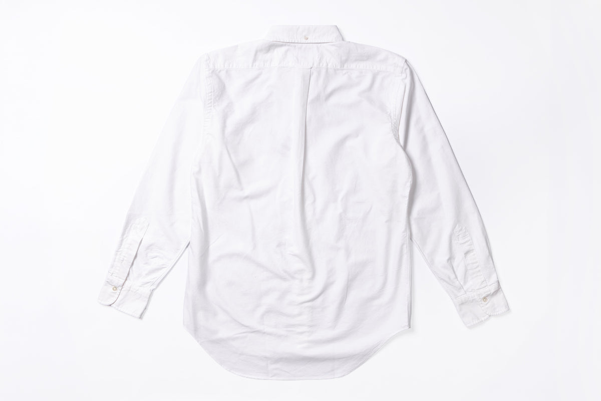 A white long-sleeve button-up shirt shown from the back, laid flat on a clean white background.