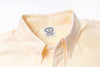 Close-up of a striped shirt with a visible label on a light gray background