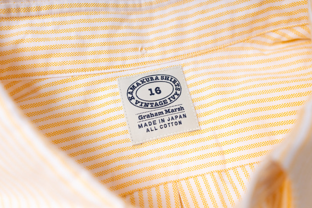 Close-up of a striped fabric with a label on a white background