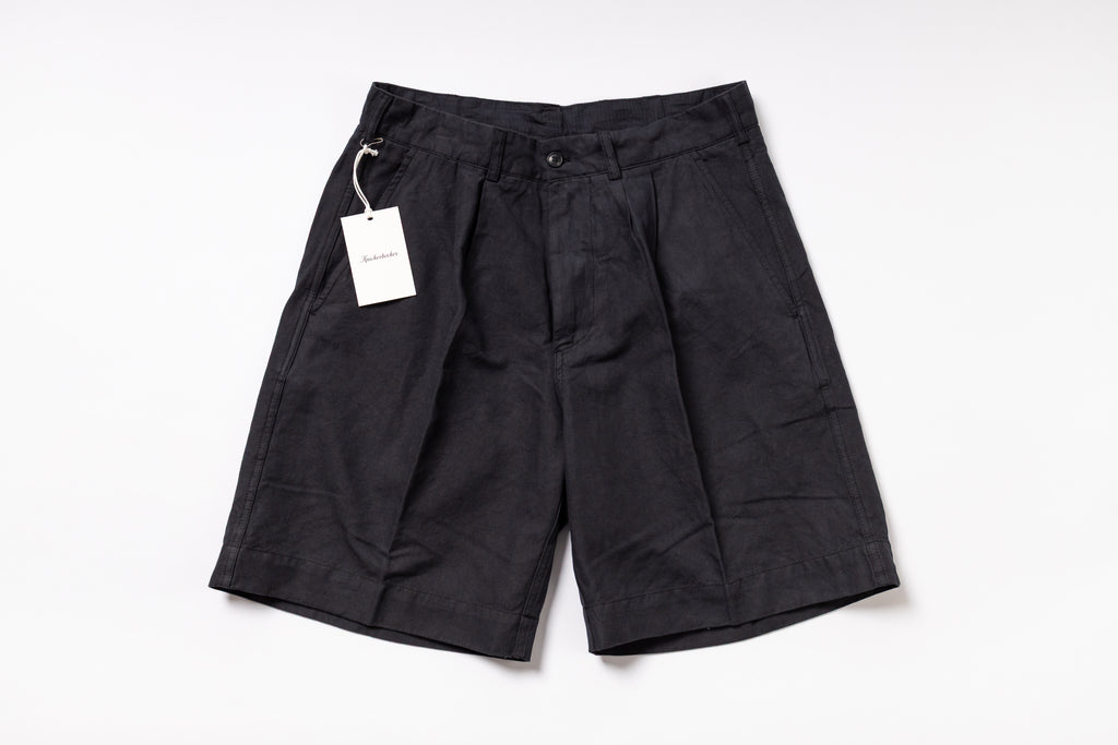Black shorts with a tag on a white background