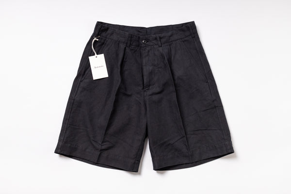 Black shorts with a tag on a white background