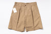 Beige shorts with a tag on a white background