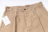 Beige pants with a tag on a white background