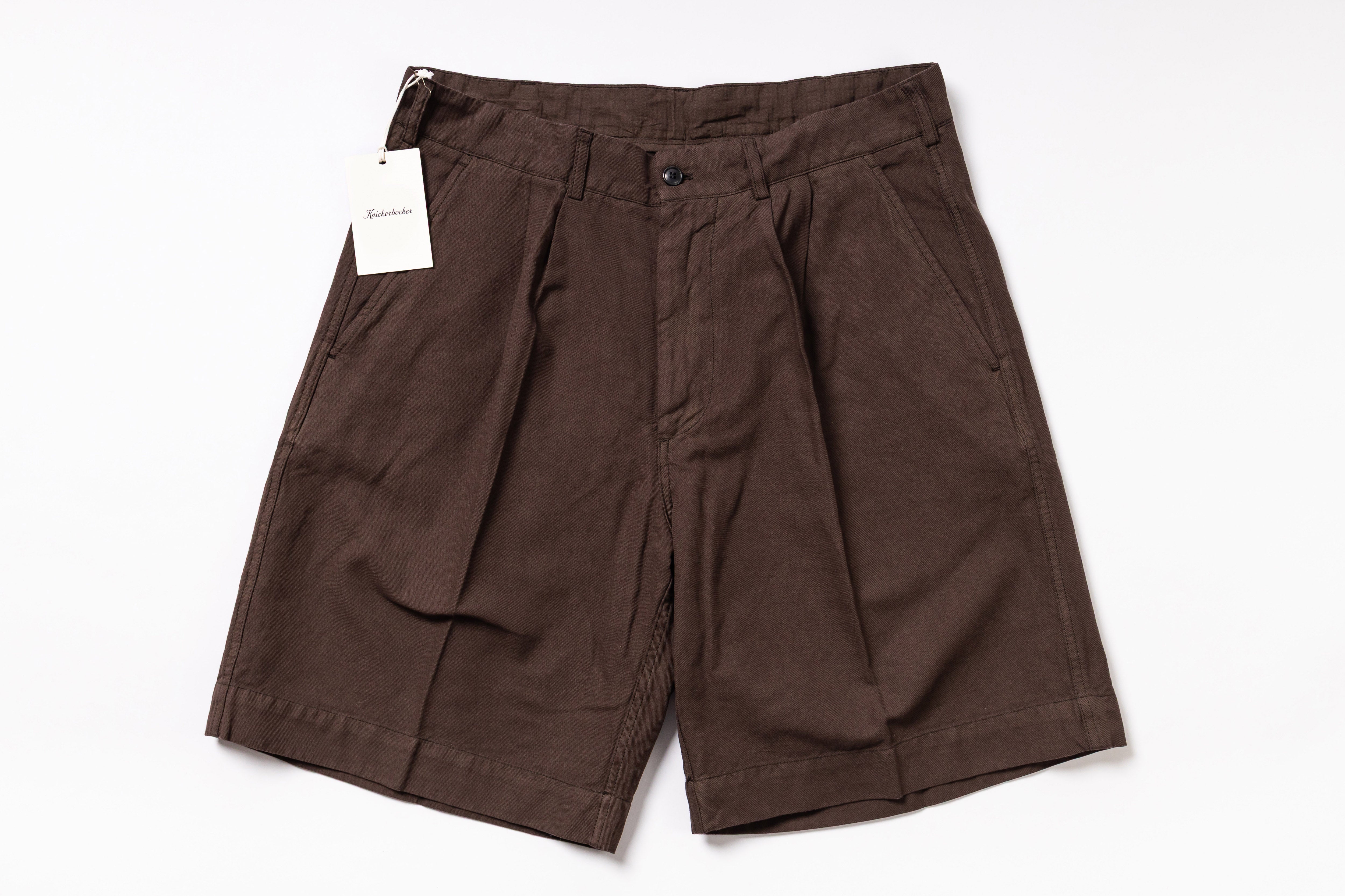 Brown shorts with a tag on a white background