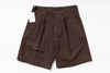 Brown shorts with a tag on a white background