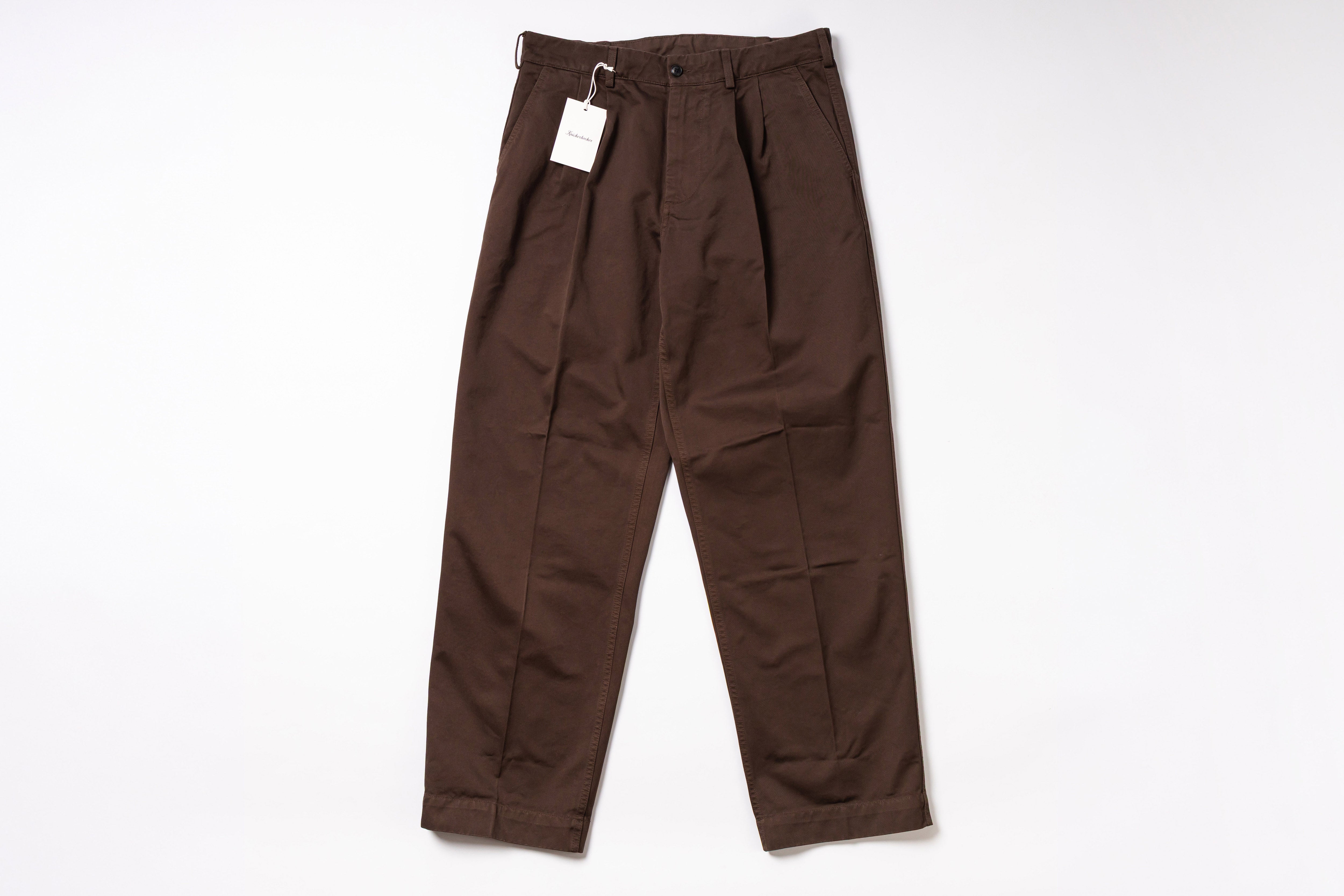 Brown pants with a tag on a white background