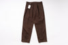 Brown pants with a tag on a white background