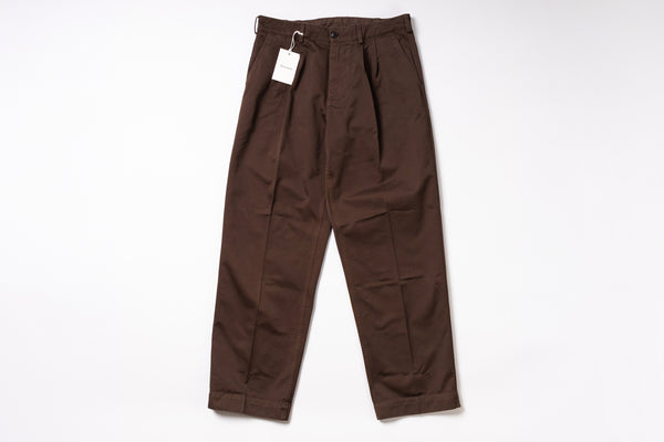 Brown pants with a tag on a white background