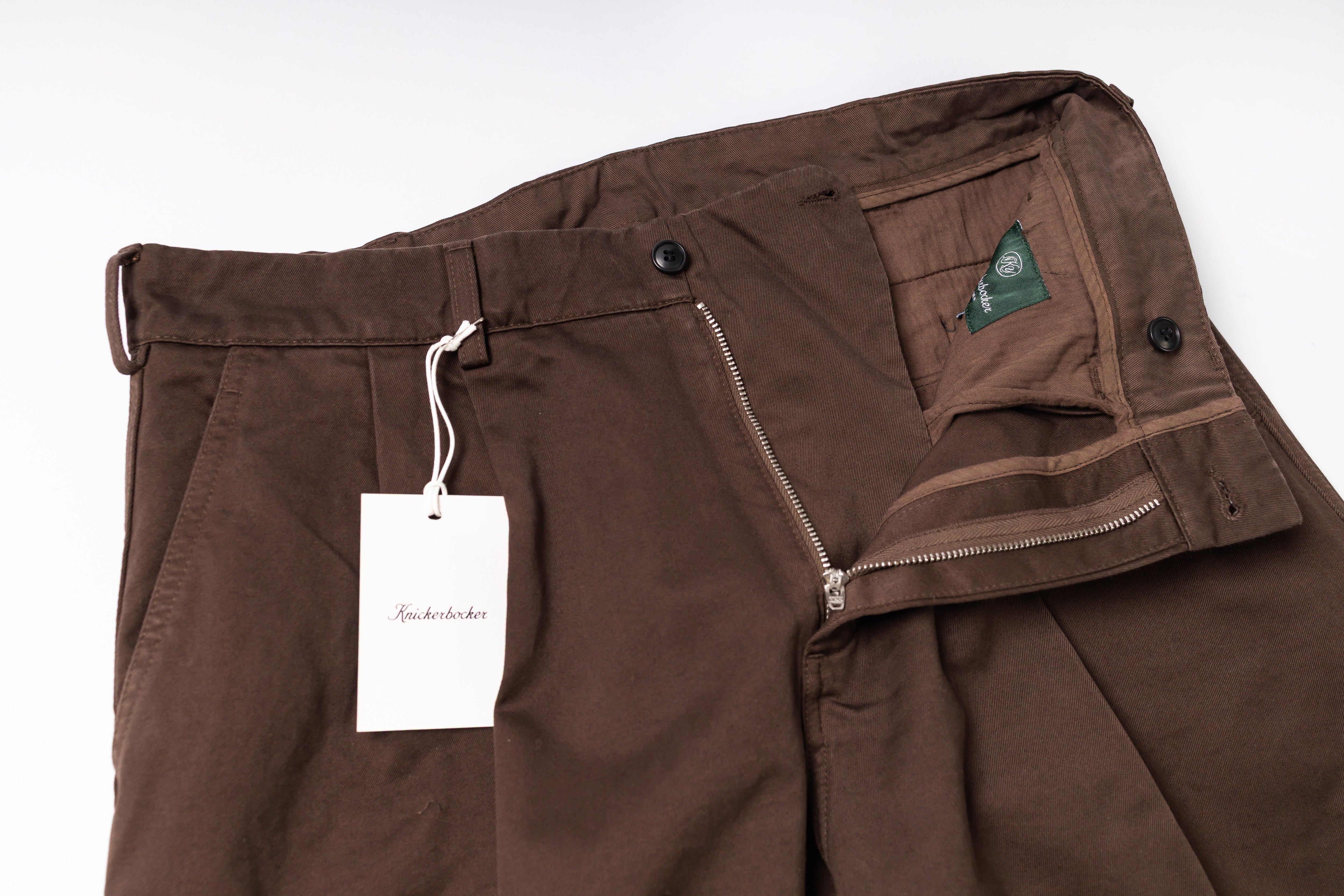 Brown pants with a tag on a white background