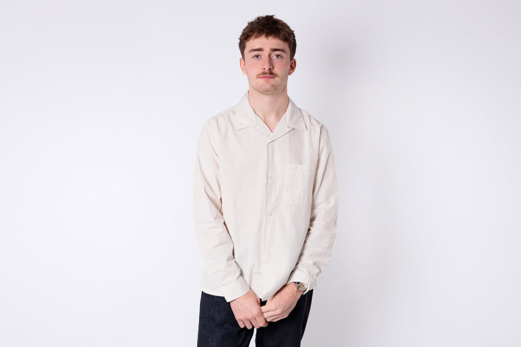 man wearing a white seersucker shirt on a white background 