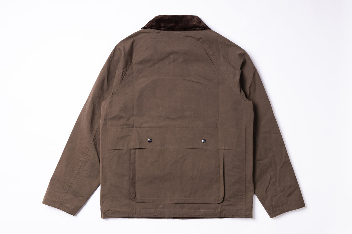 A brown utility jacket shown from the back, featuring a dark brown collar and two front flap pockets with snap buttons on the back, laid flat on a white background.