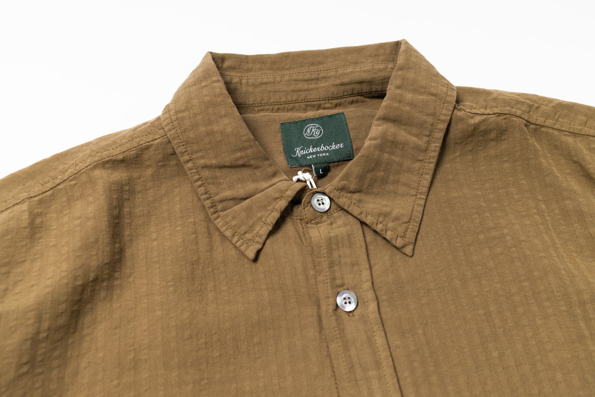 Collar of a olive shirt on a white background