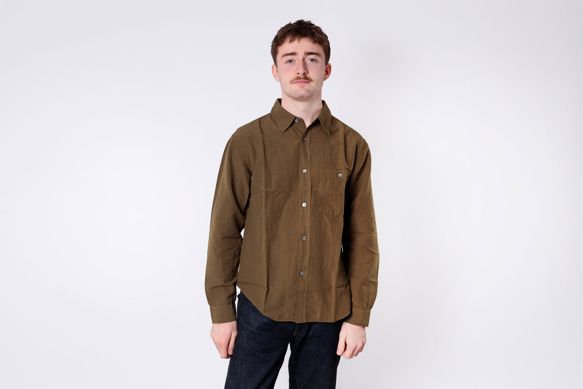 A man wearing an olive shirt