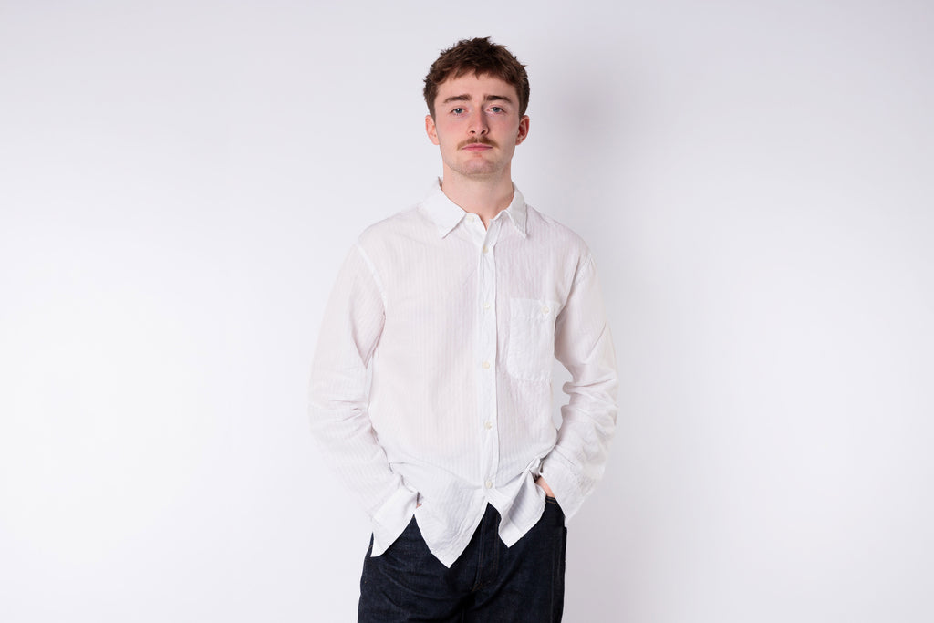 A man wearing a white shirt on a white background