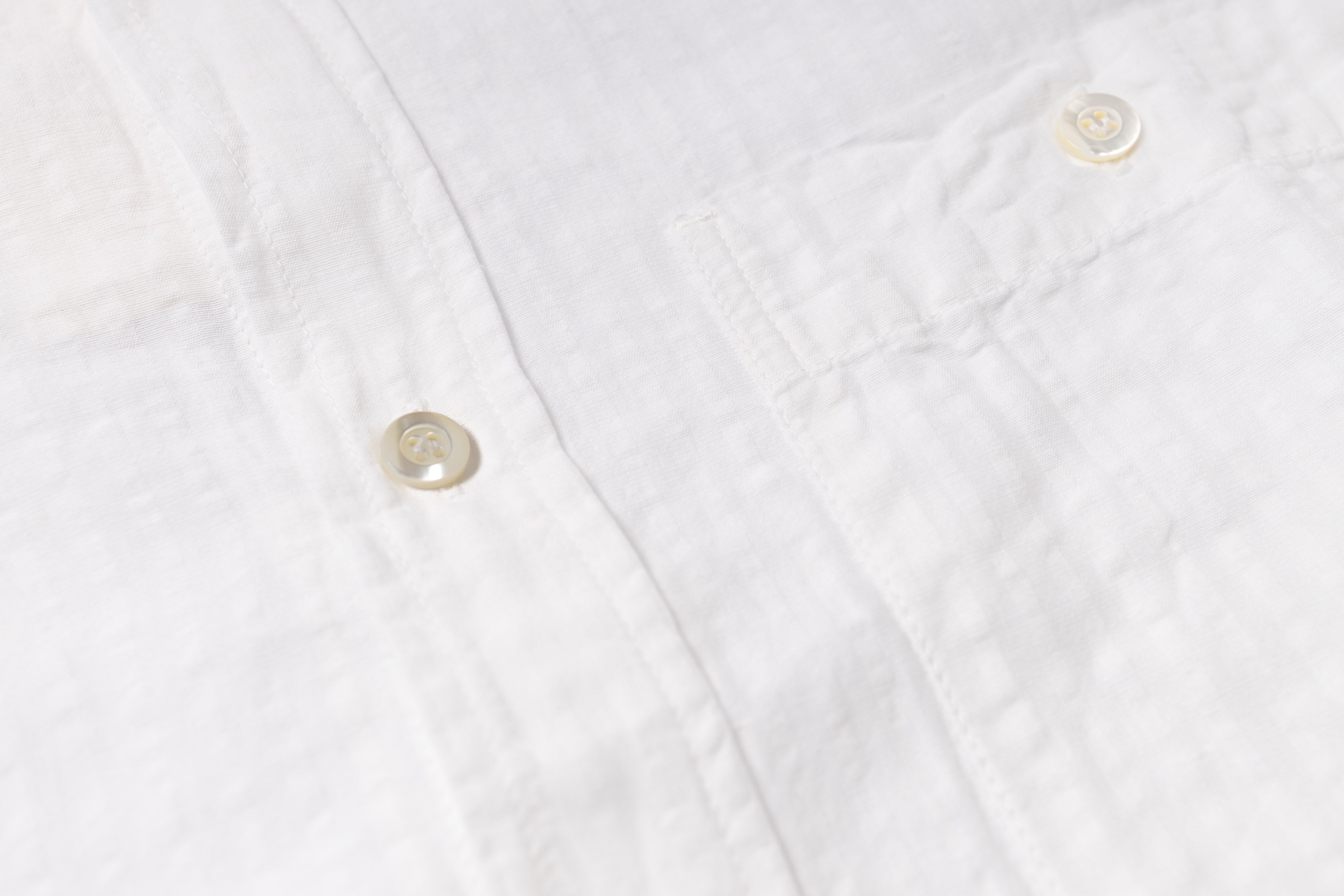 Texture of a white cotton-linen shirt on a white background