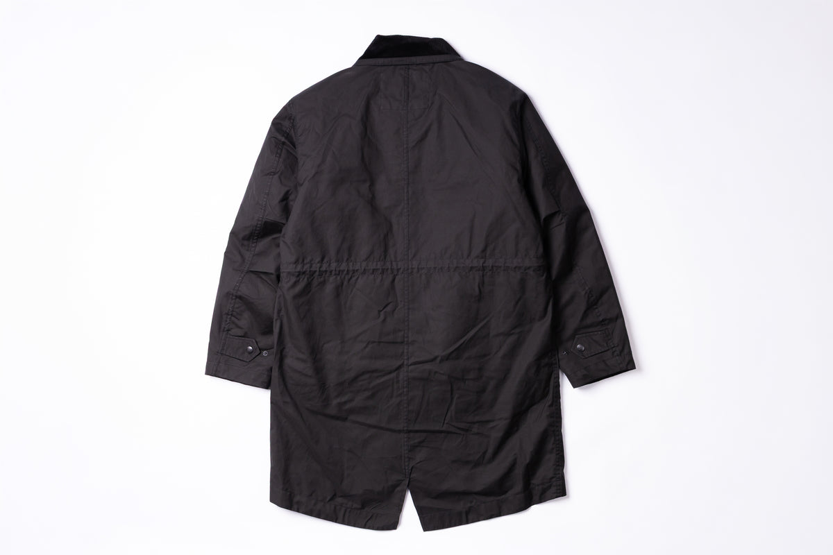 A black utility jacket shown from the back, laid flat against a clean white background.