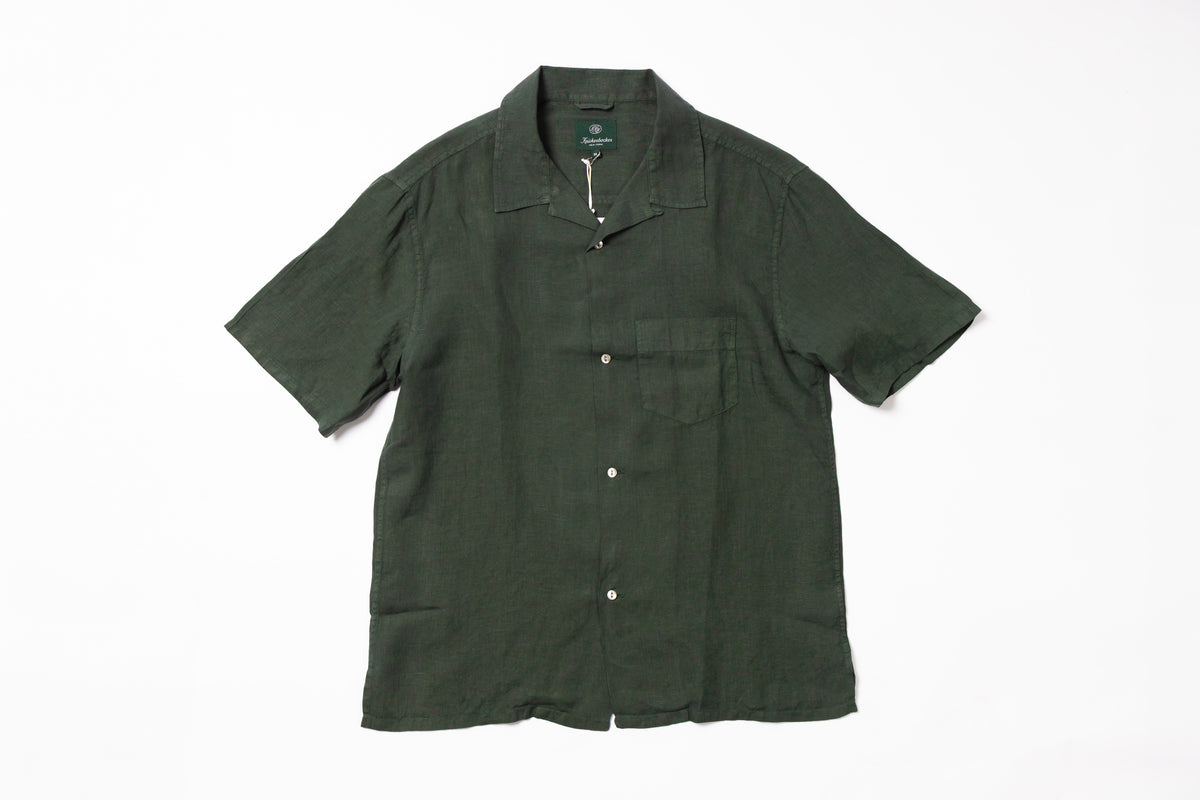 A green linen shirt on a white background