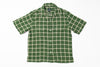 Green checkered shirt on a white background
