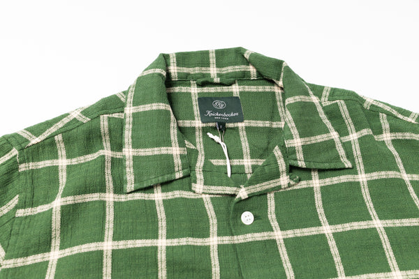 Green and white checkered shirt with a brand label on a white background