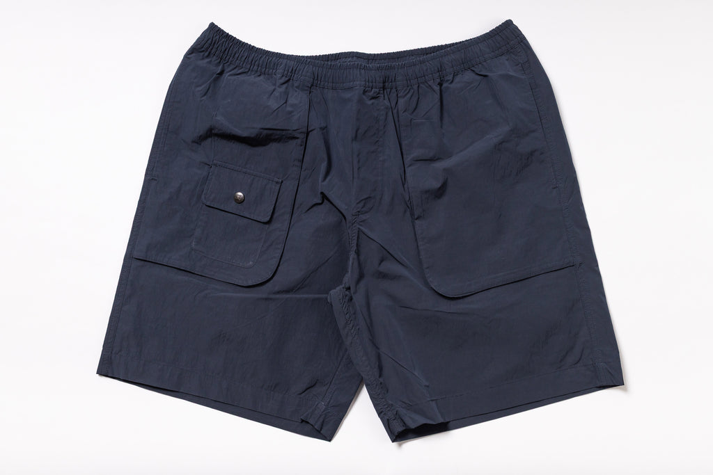 Navy blue shorts with a pocket on a white background