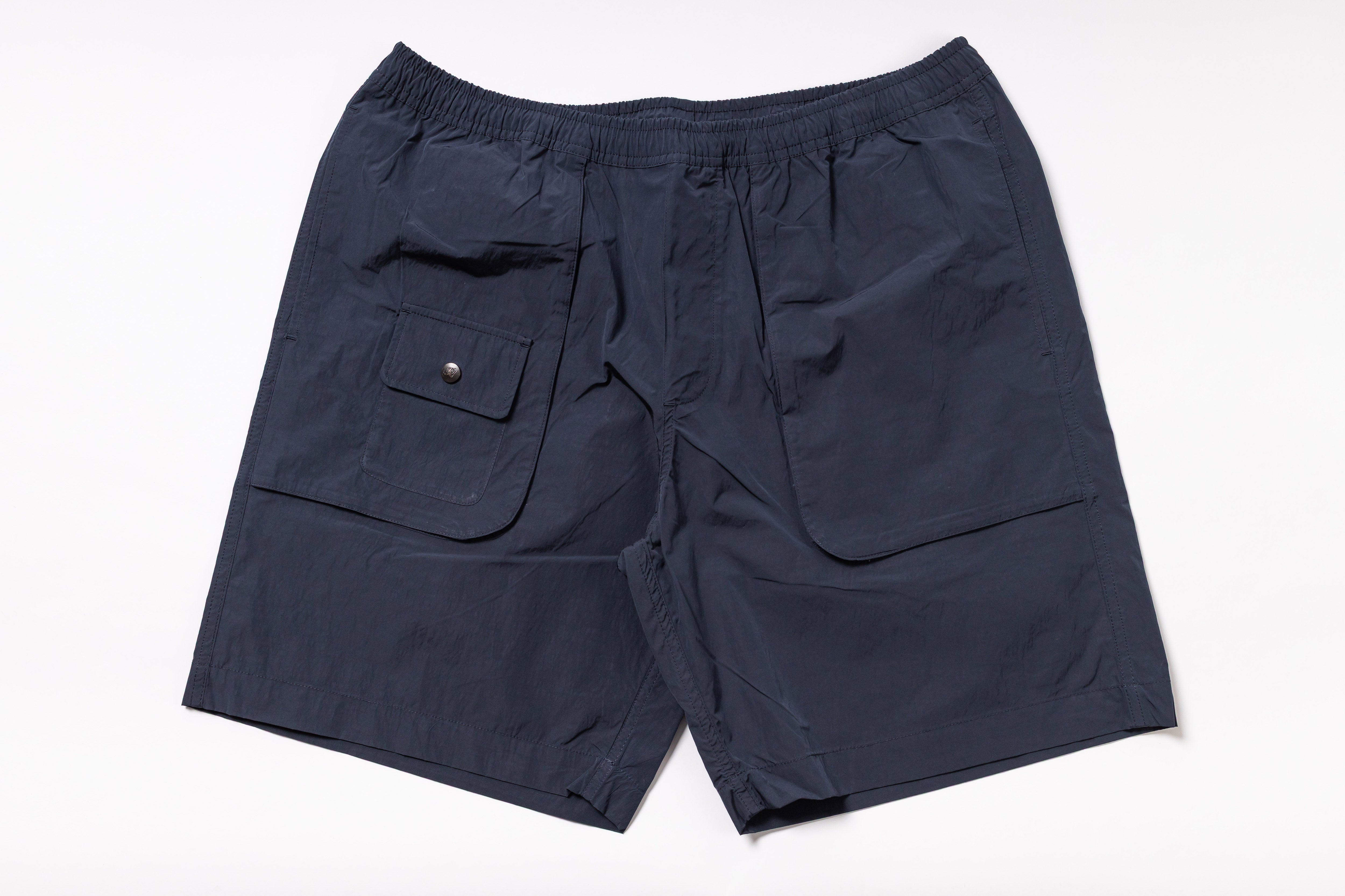 Navy blue shorts with a pocket on a white background