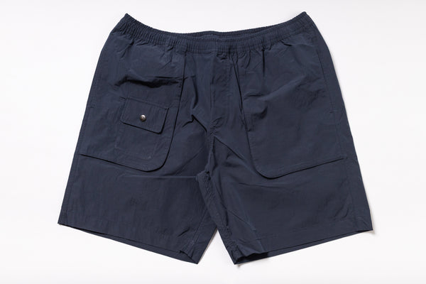 Navy blue shorts with a pocket on a white background